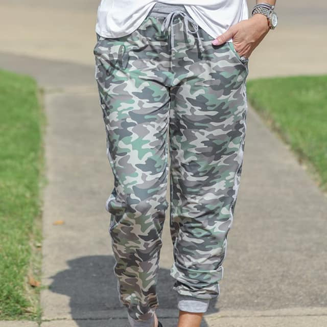 mid-rise fit joggers with side pockets and a tie waist drawstring, designed on a camo pattern print with gray trim
