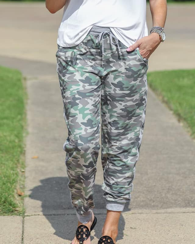 mid-rise fit joggers with side pockets and a tie waist drawstring, designed on a camo pattern print with gray trim
