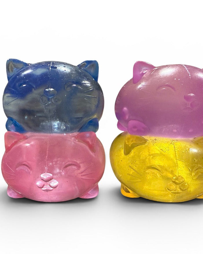 a soft jelly-like chubby kitty squishy with closed eyes, a super slow-rising texture, a stretchy squeezable feel, and a bright translucent color available in blue, pink, purple, and yellow