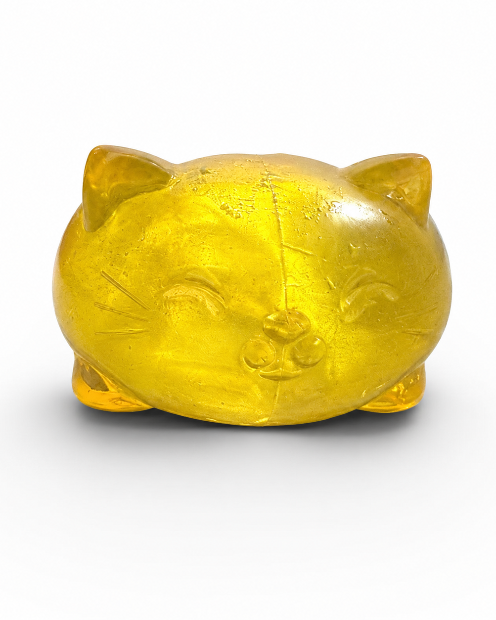 a soft yellow jelly-like chubby kitty squishy with closed eyes, a super slow-rising texture, a stretchy squeezable feel, and a bright translucent color