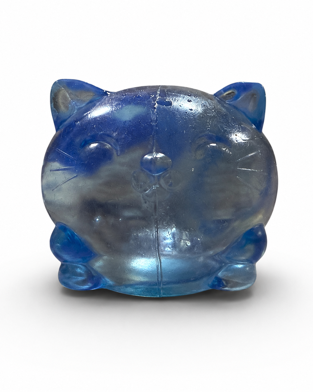 a soft blue jelly-like chubby kitty squishy with closed eyes, a super slow-rising texture, a stretchy squeezable feel, and a bright translucent color