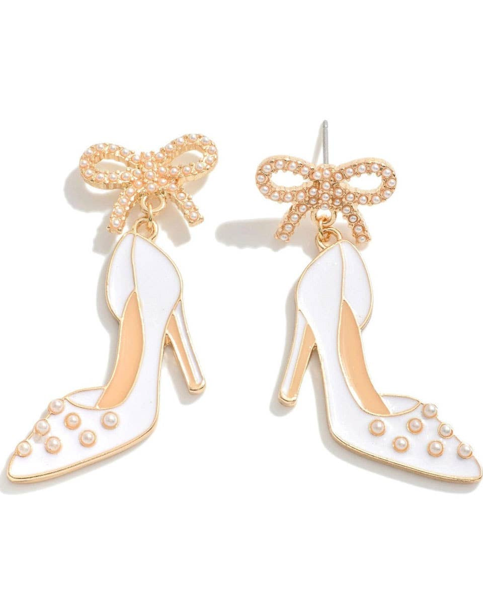 High-heeled shoe earrings with gold accents and bows on a white background