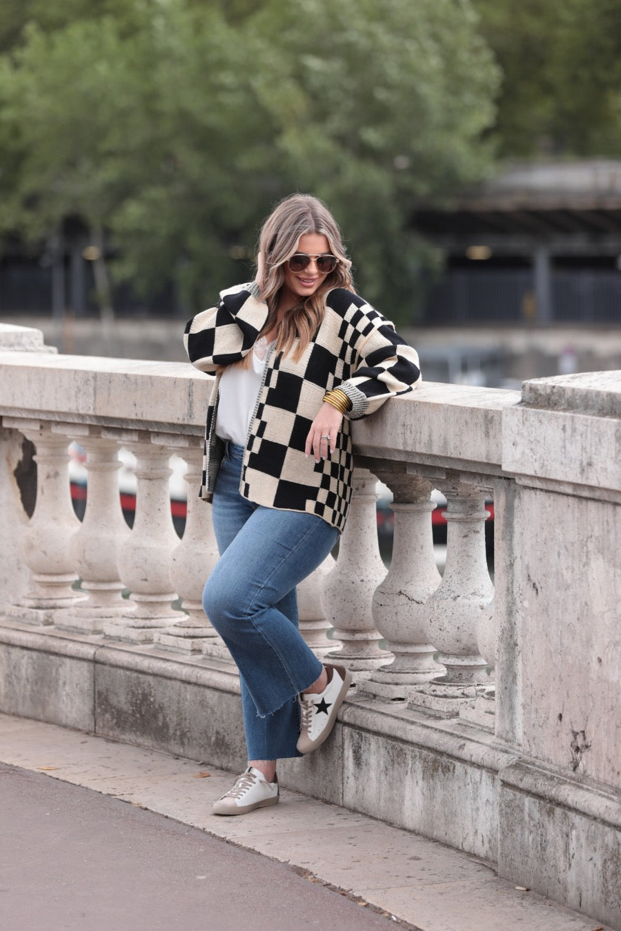long-sleeve open front cardigan with balloon sleeves and a checkered pattern in tan/black