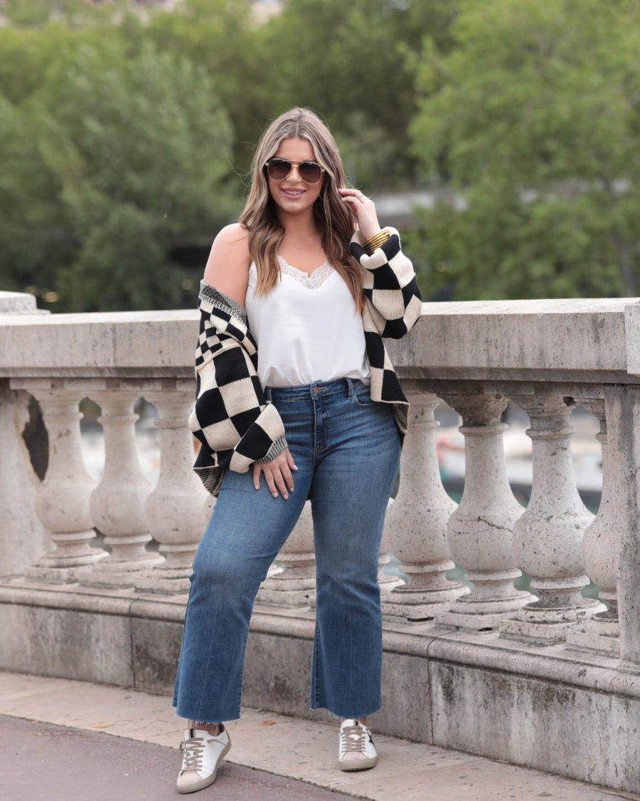 long-sleeve open front cardigan with balloon sleeves and a checkered pattern in tan/black