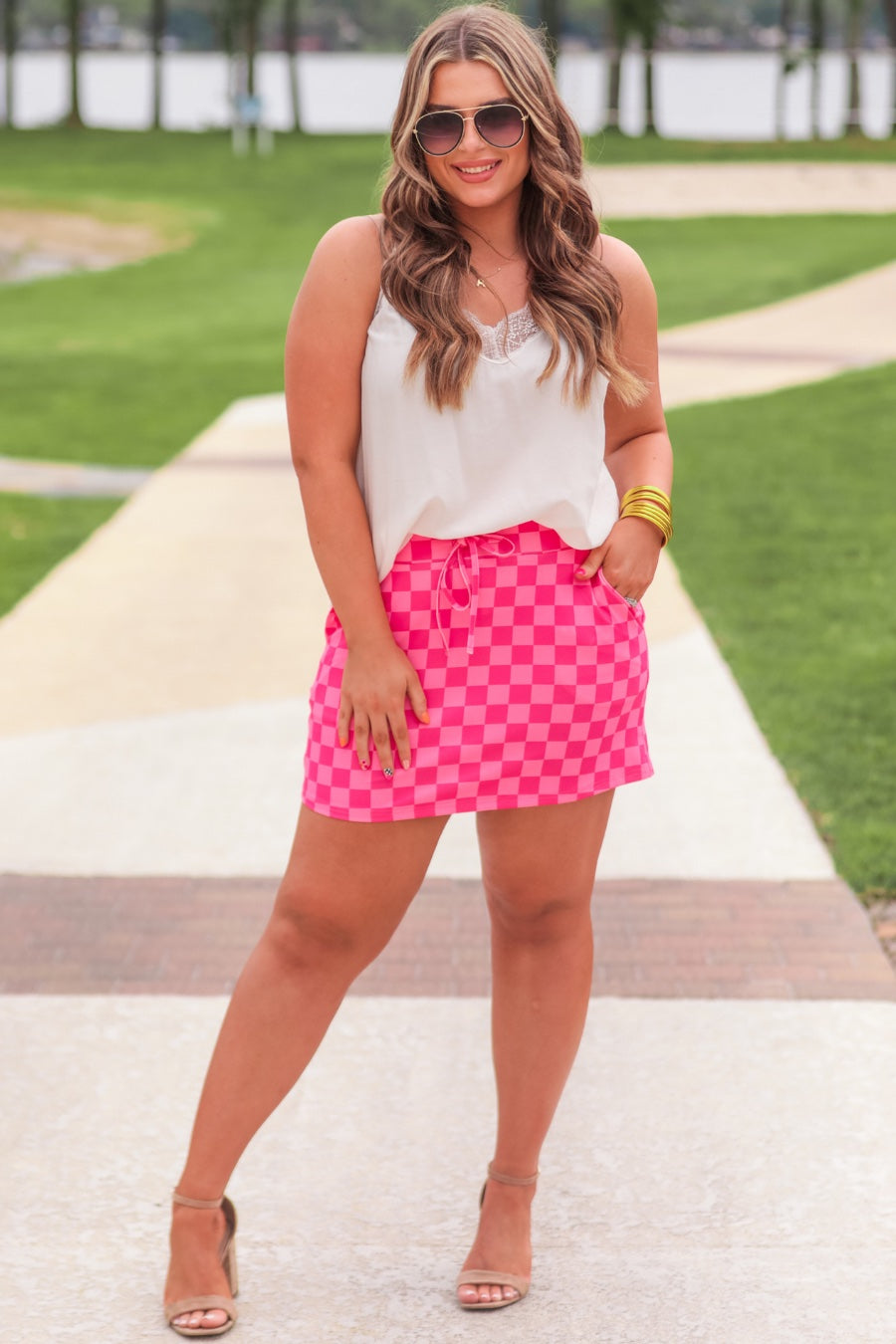 mid-rise relaxed fit everyday skort made of lightweight material with built-in ivory shorts, drawstring tie, an elastic band on the back, and side pockets, designed on a two-tone pink checkered pattern print
