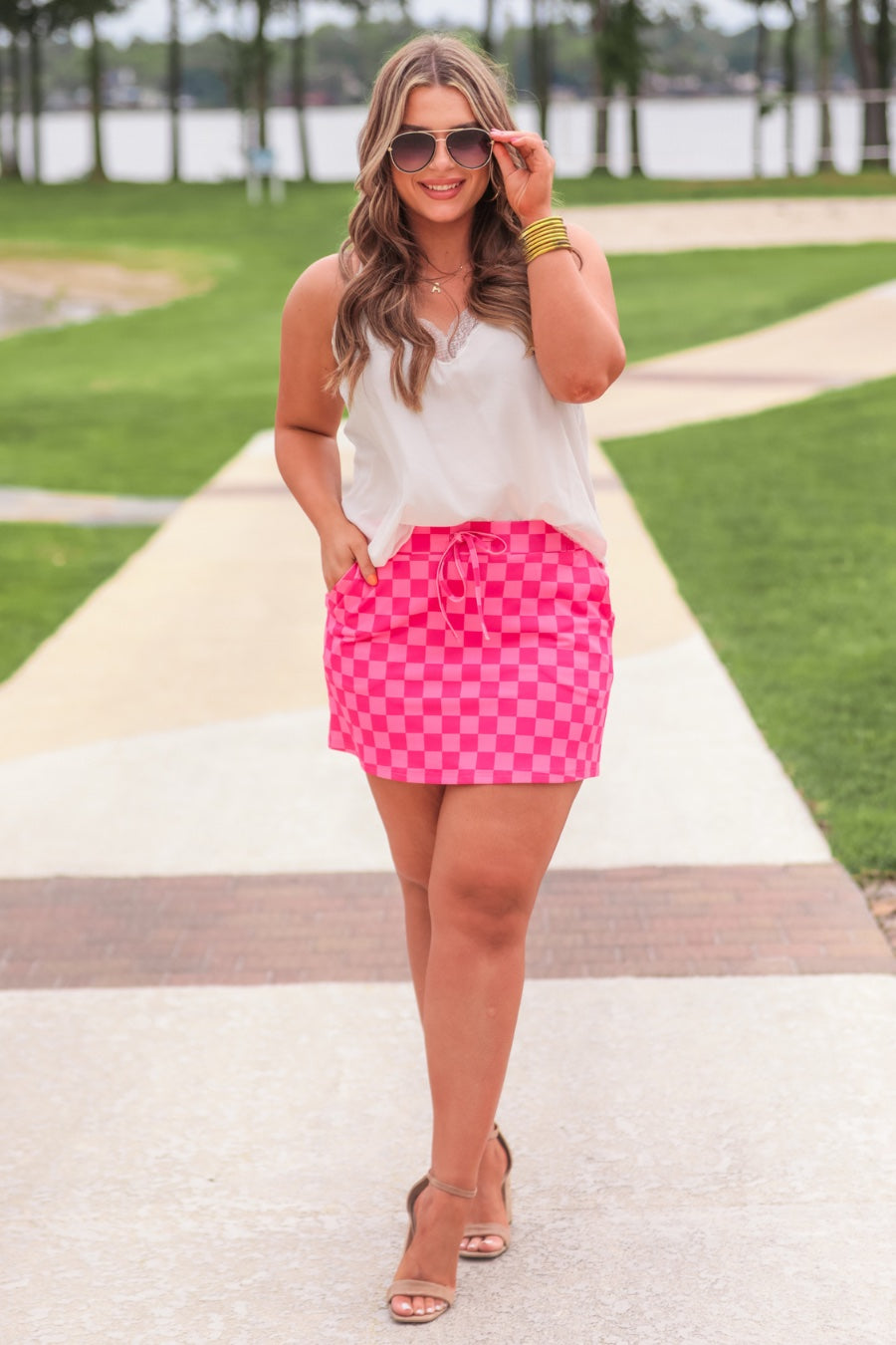 mid-rise relaxed fit everyday skort made of lightweight material with built-in ivory shorts, drawstring tie, an elastic band on the back, and side pockets, designed on a two-tone pink checkered pattern print