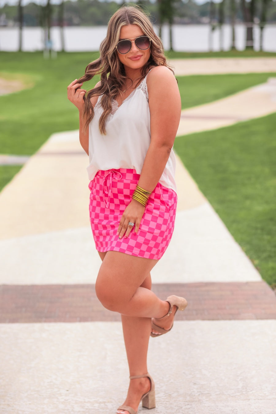 mid-rise relaxed fit everyday skort made of lightweight material with built-in ivory shorts, drawstring tie, an elastic band on the back, and side pockets, designed on a two-tone pink checkered pattern print