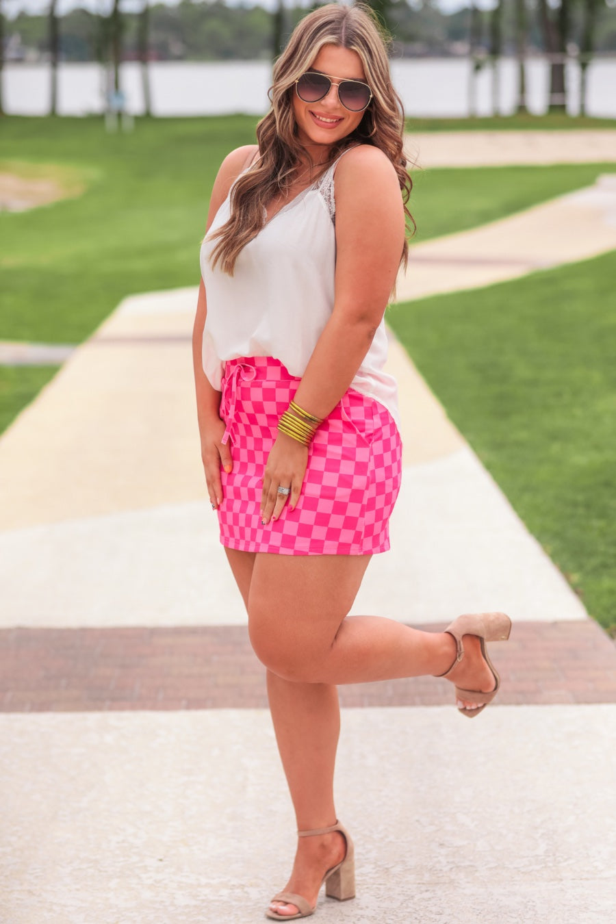 mid-rise relaxed fit everyday skort made of lightweight material with built-in ivory shorts, drawstring tie, an elastic band on the back, and side pockets, designed on a two-tone pink checkered pattern print
