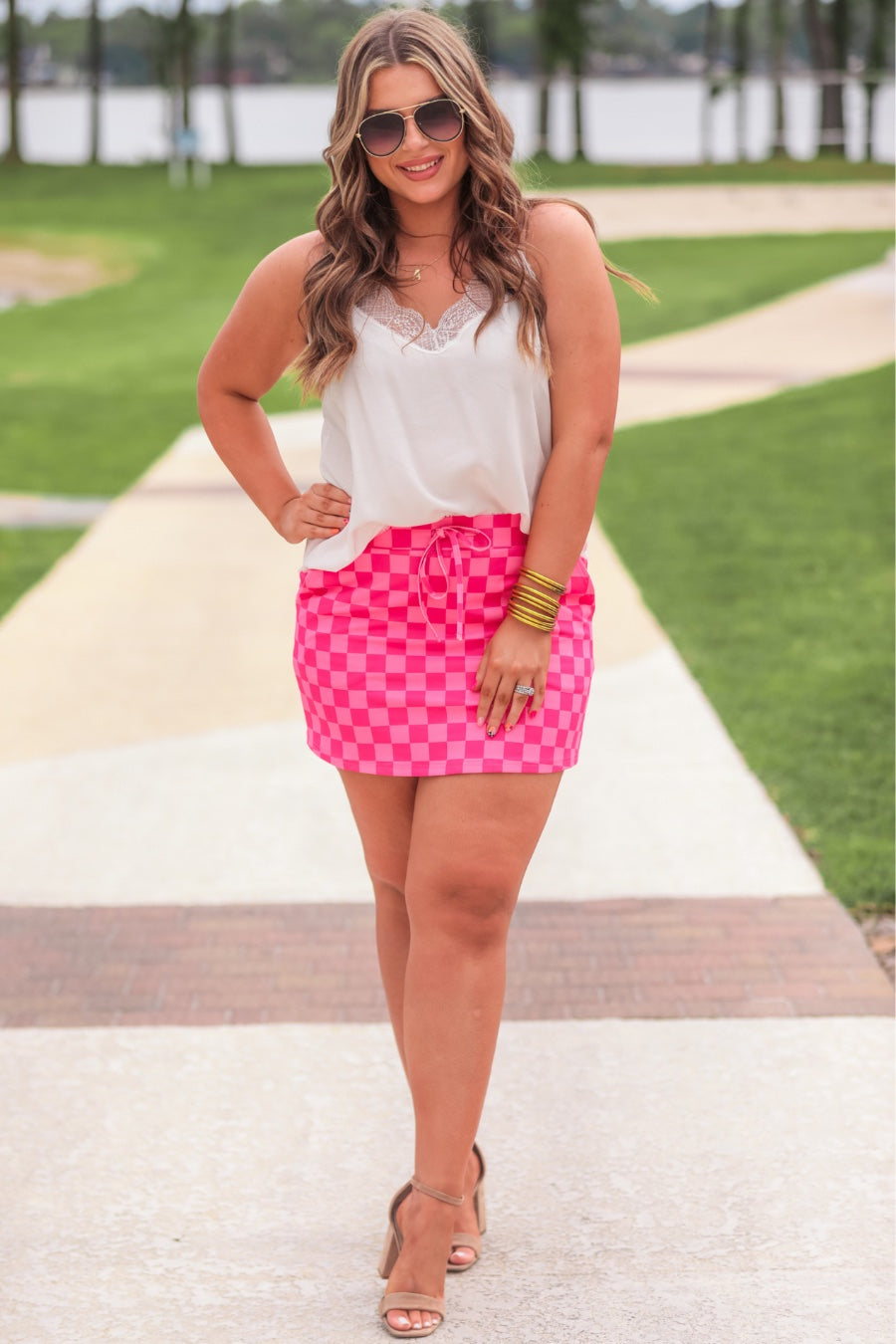 mid-rise relaxed fit everyday skort made of lightweight material with built-in ivory shorts, drawstring tie, an elastic band on the back, and side pockets, designed on a two-tone pink checkered pattern print