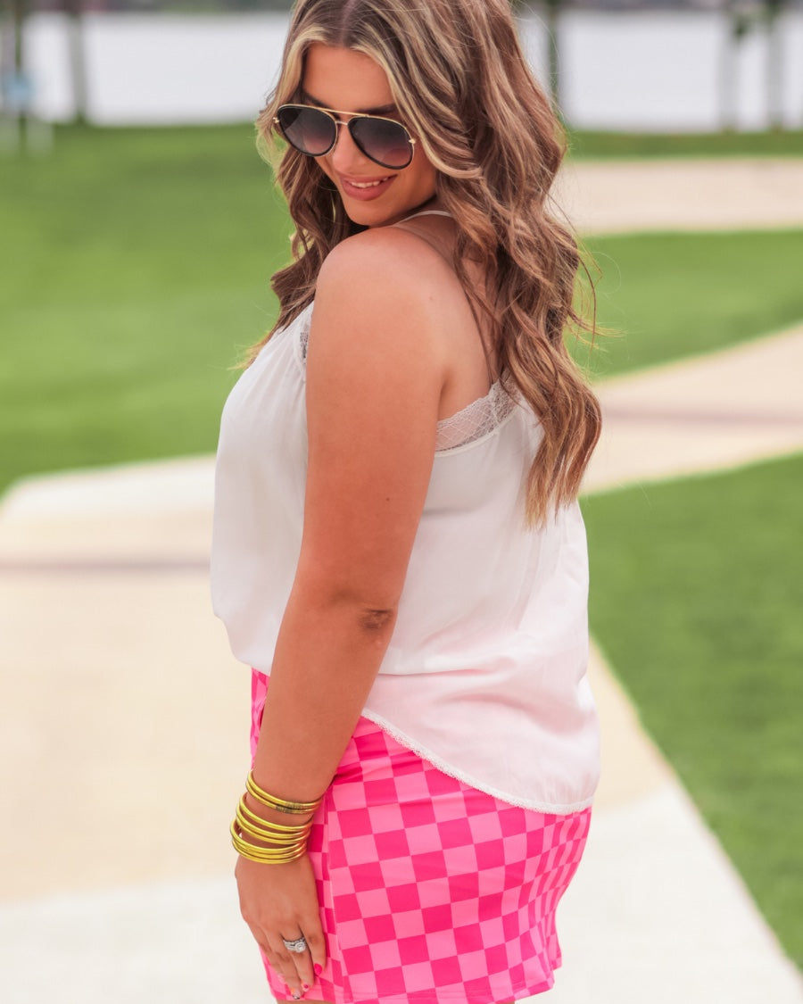 mid-rise relaxed fit everyday skort made of lightweight material with built-in ivory shorts, drawstring tie, an elastic band on the back, and side pockets, designed on a two-tone pink checkered pattern print
