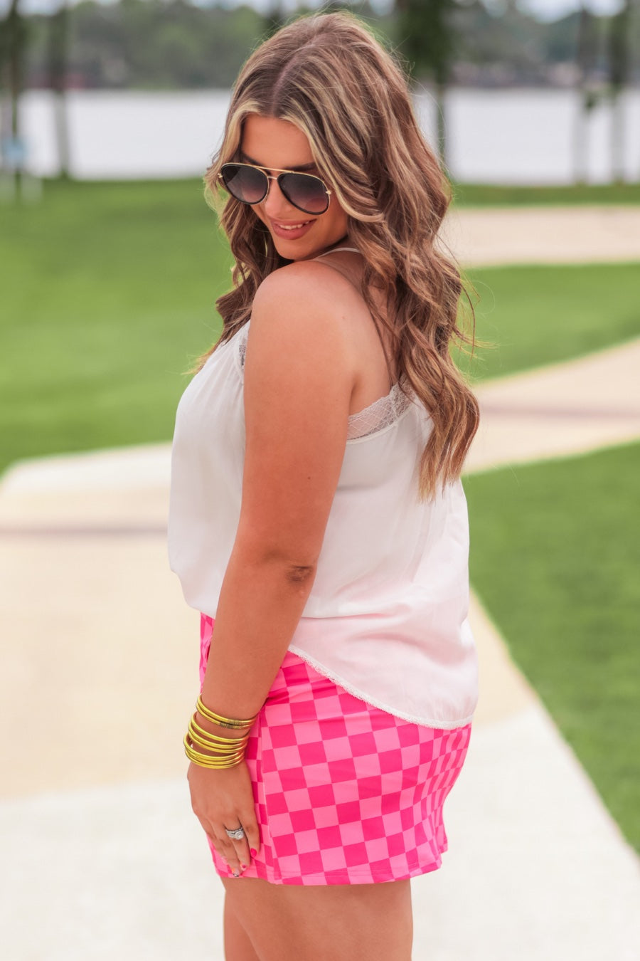 mid-rise relaxed fit everyday skort made of lightweight material with built-in ivory shorts, drawstring tie, an elastic band on the back, and side pockets, designed on a two-tone pink checkered pattern print