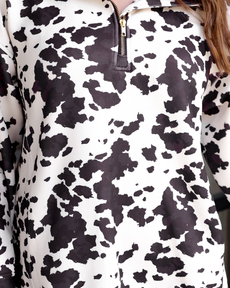long-sleeve pullover crafted from our best-selling everyday fabric in a bold brown and cream cowhide pattern print, structured collar, functional gold zipper, kangaroo pocket, side slits, and a back yoke seam