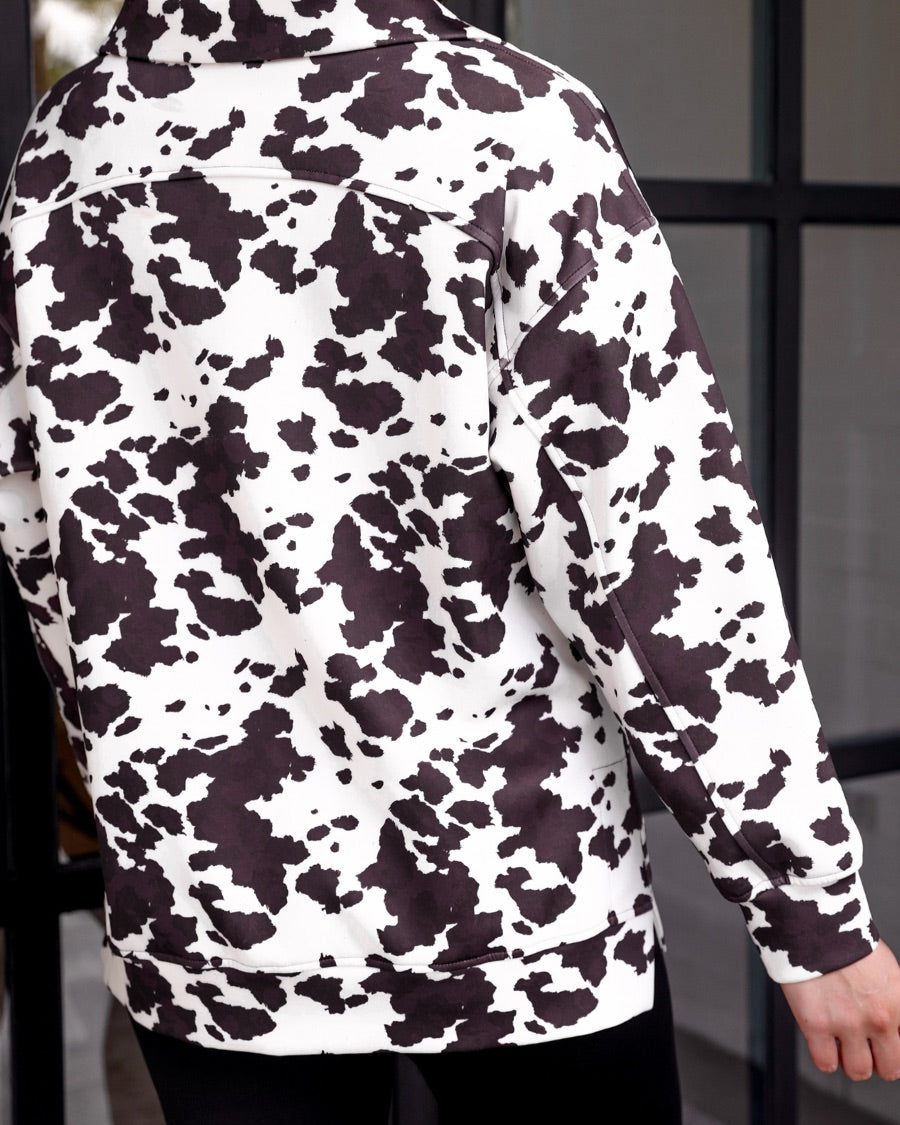 long-sleeve pullover crafted from our best-selling everyday fabric in a bold brown and cream cowhide pattern print, structured collar, functional gold zipper, kangaroo pocket, side slits, and a back yoke seam