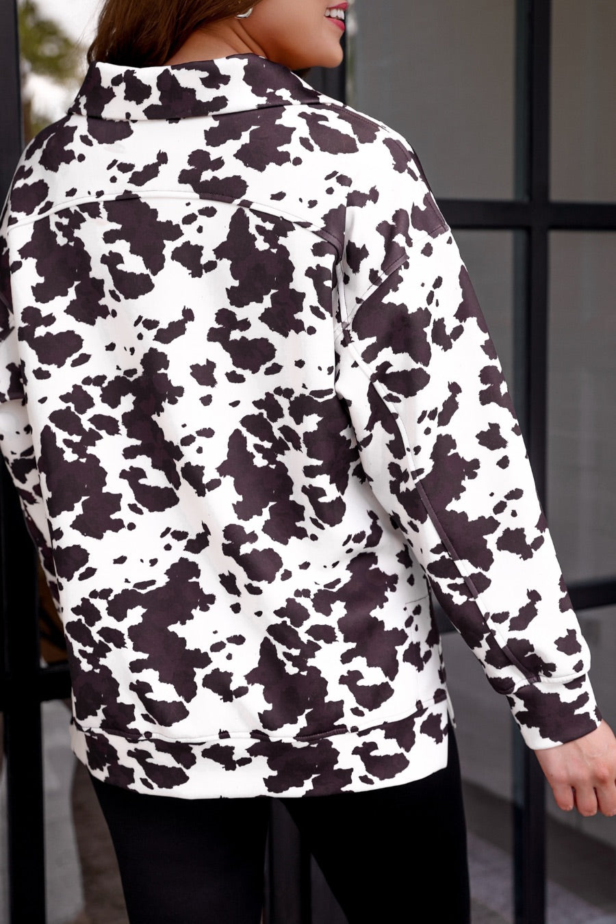 long-sleeve pullover crafted from our best-selling everyday fabric in a bold brown and cream cowhide pattern print, structured collar, functional gold zipper, kangaroo pocket, side slits, and a back yoke seam