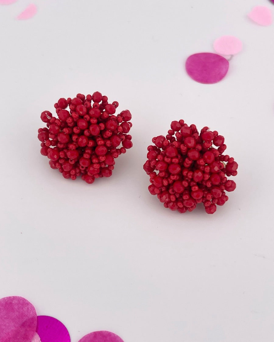 mix of size beads in a pom shape with a clip-on closure
