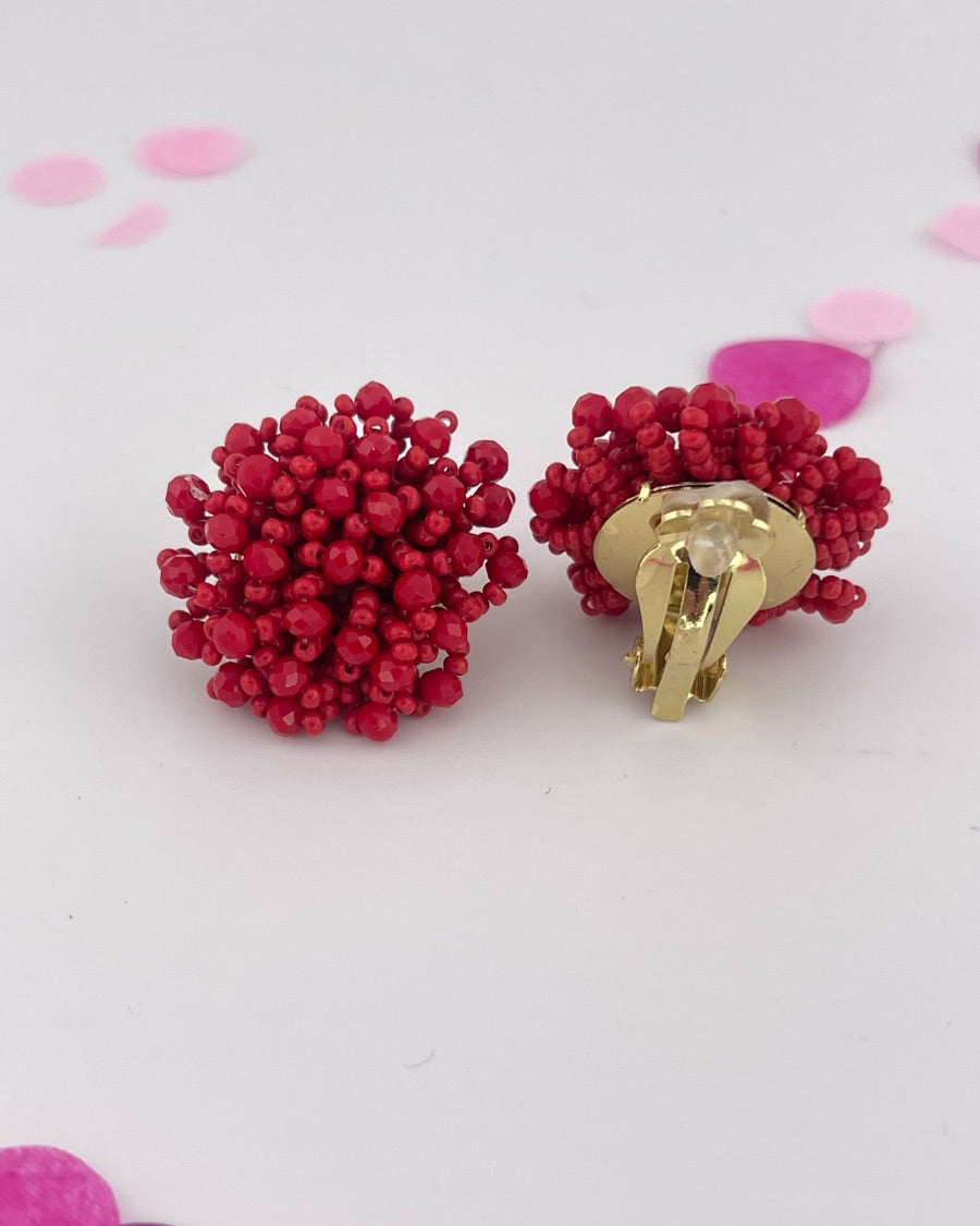mix of size beads in a pom shape with a clip-on closure