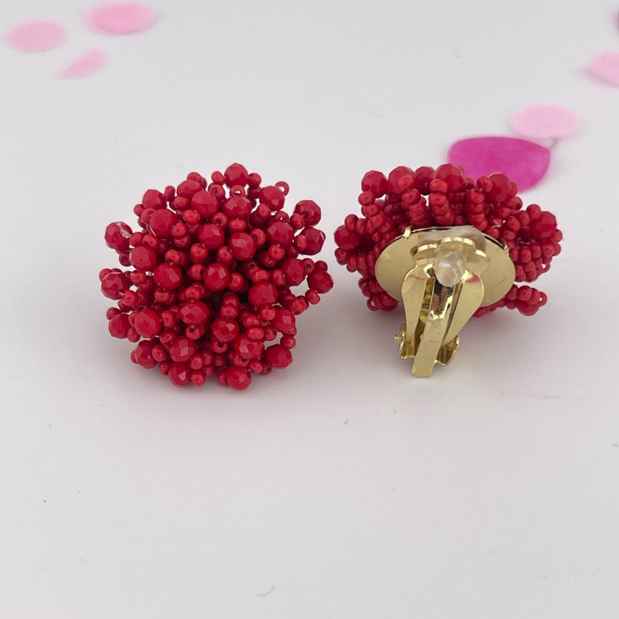 mix of size beads in a pom shape with a clip-on closure