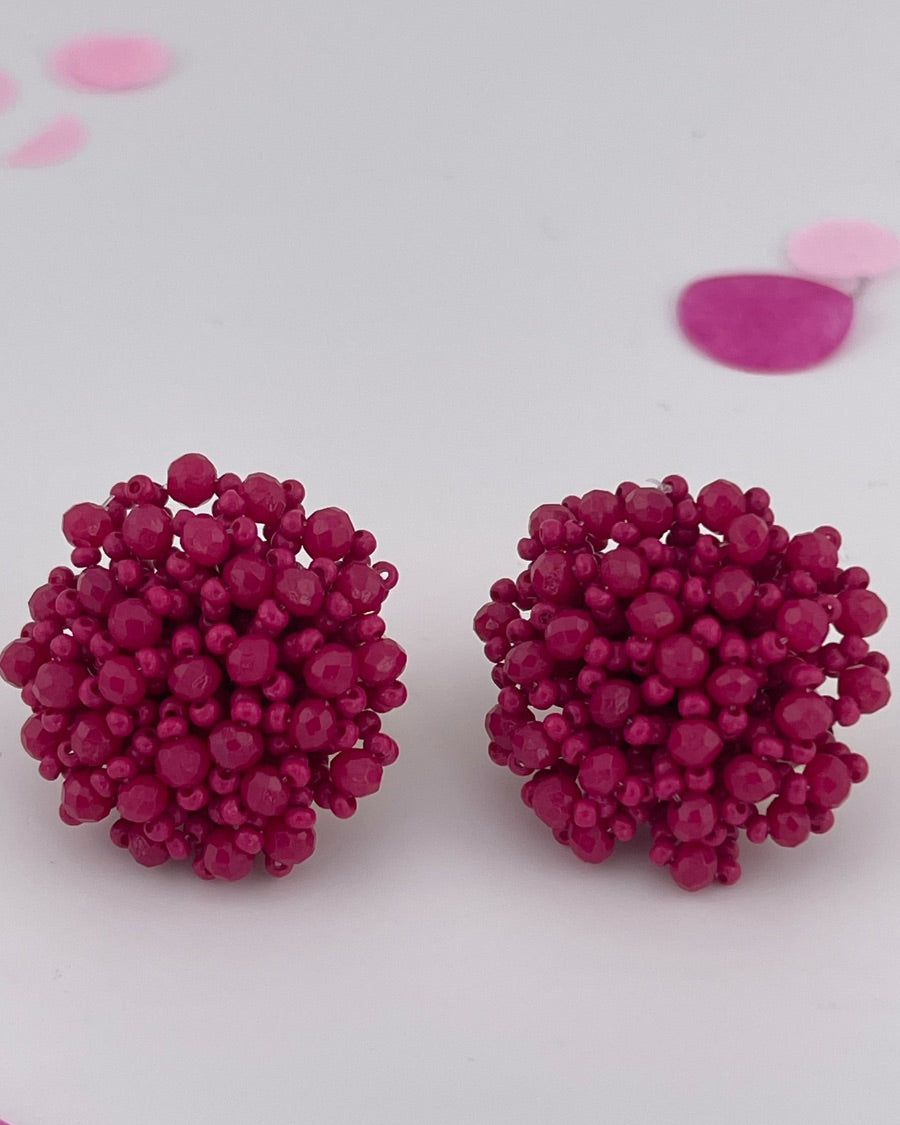 mix of size beads in a pom shape with a clip-on closure