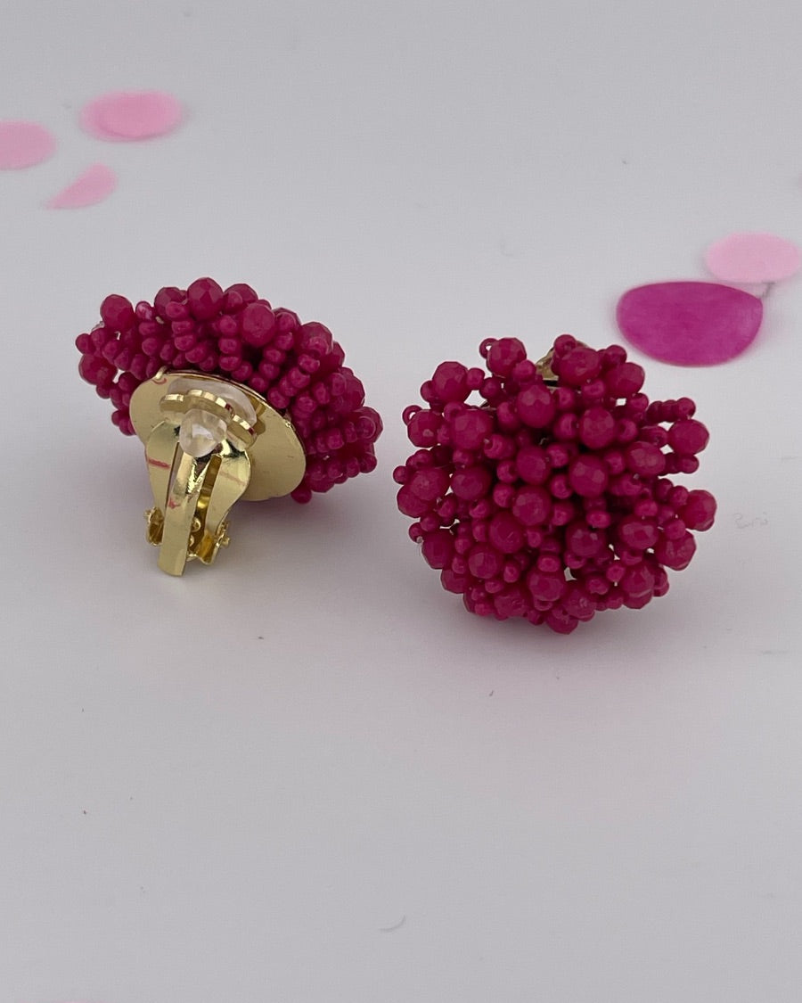 mix of size beads in a pom shape with a clip-on closure
