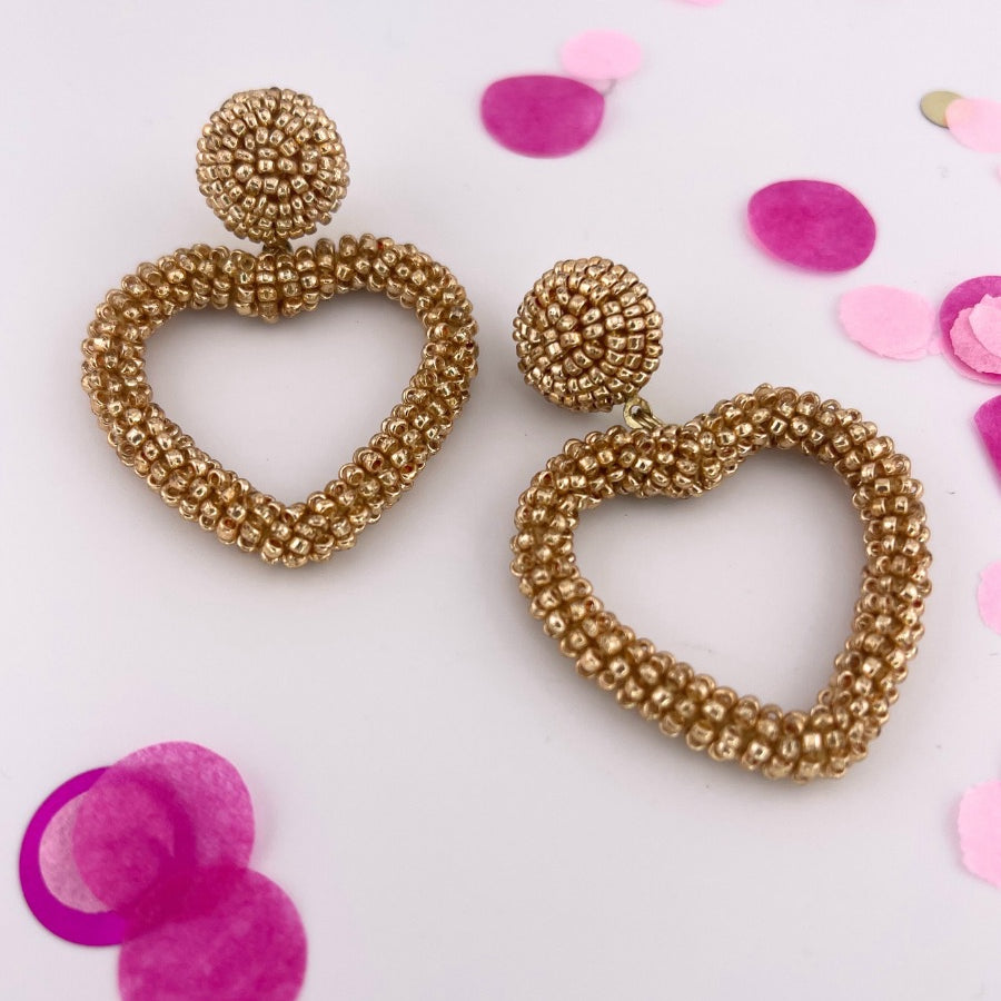 a gold beaded post stud with a matching beaded open heart-shape drop and a comfort earring back in gold