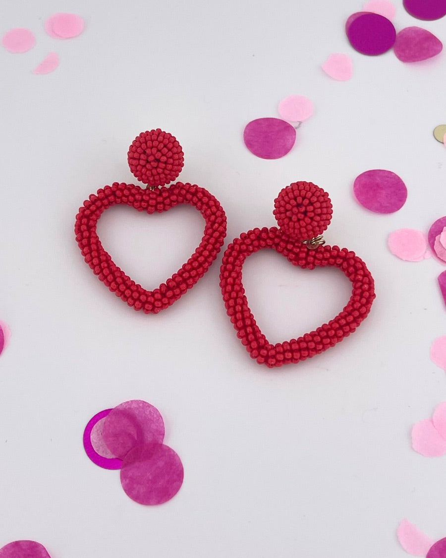 a red beaded post stud with a matching beaded open heart-shape drop and a comfort earring back in gold