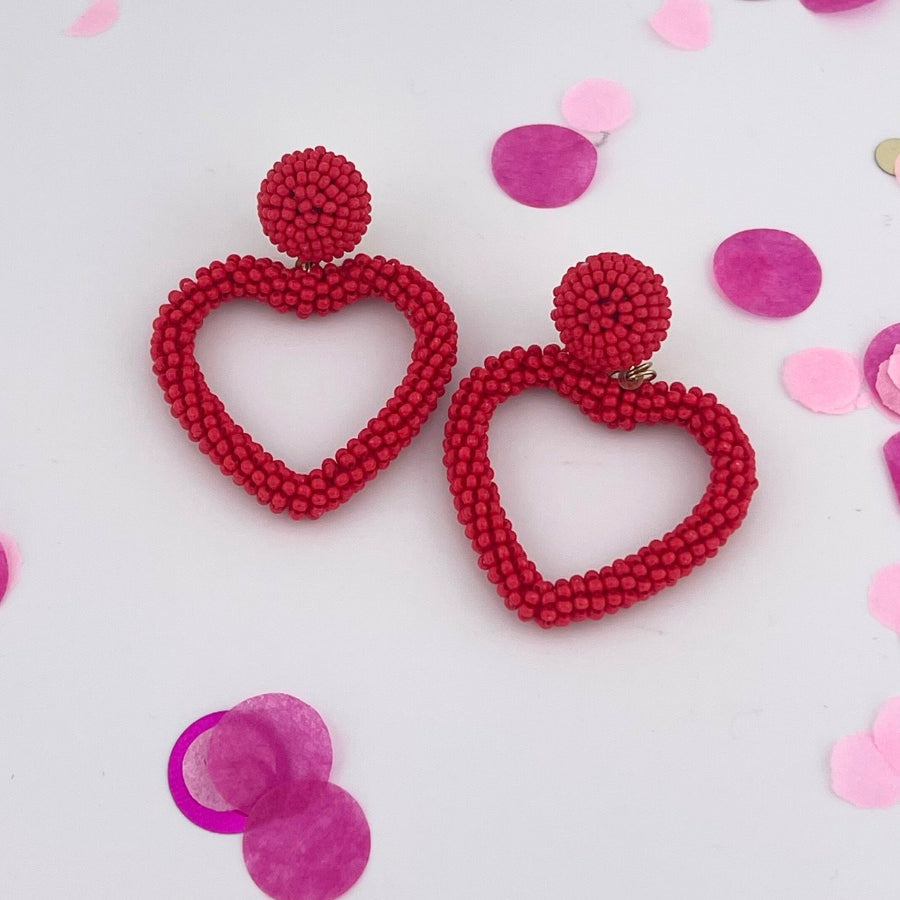 a red beaded post stud with a matching beaded open heart-shape drop and a comfort earring back in gold