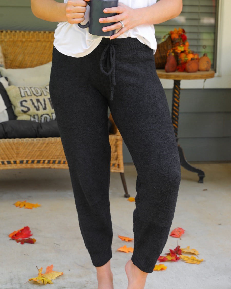 solid black joggers made from super soft fabric with an elastic waistband and a slim fit