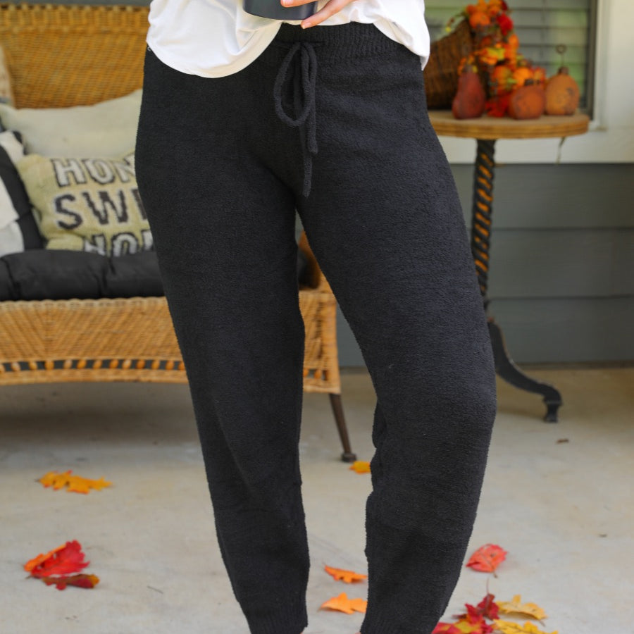 solid black joggers made from super soft fabric with an elastic waistband and a slim fit