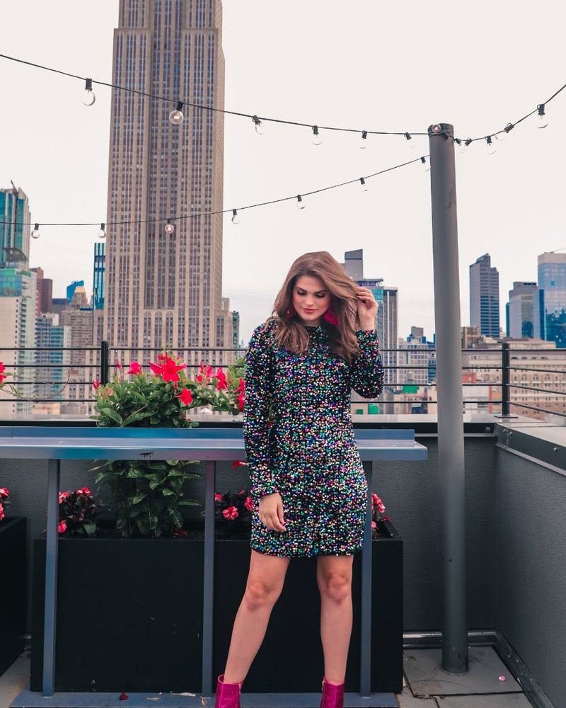 a multicolor long-sleeve dress with shimmering allover sequins detailing, a flattering silhouette, a soft-lined interior, and a back zipper that extends two-thirds down for a polished, easy fit