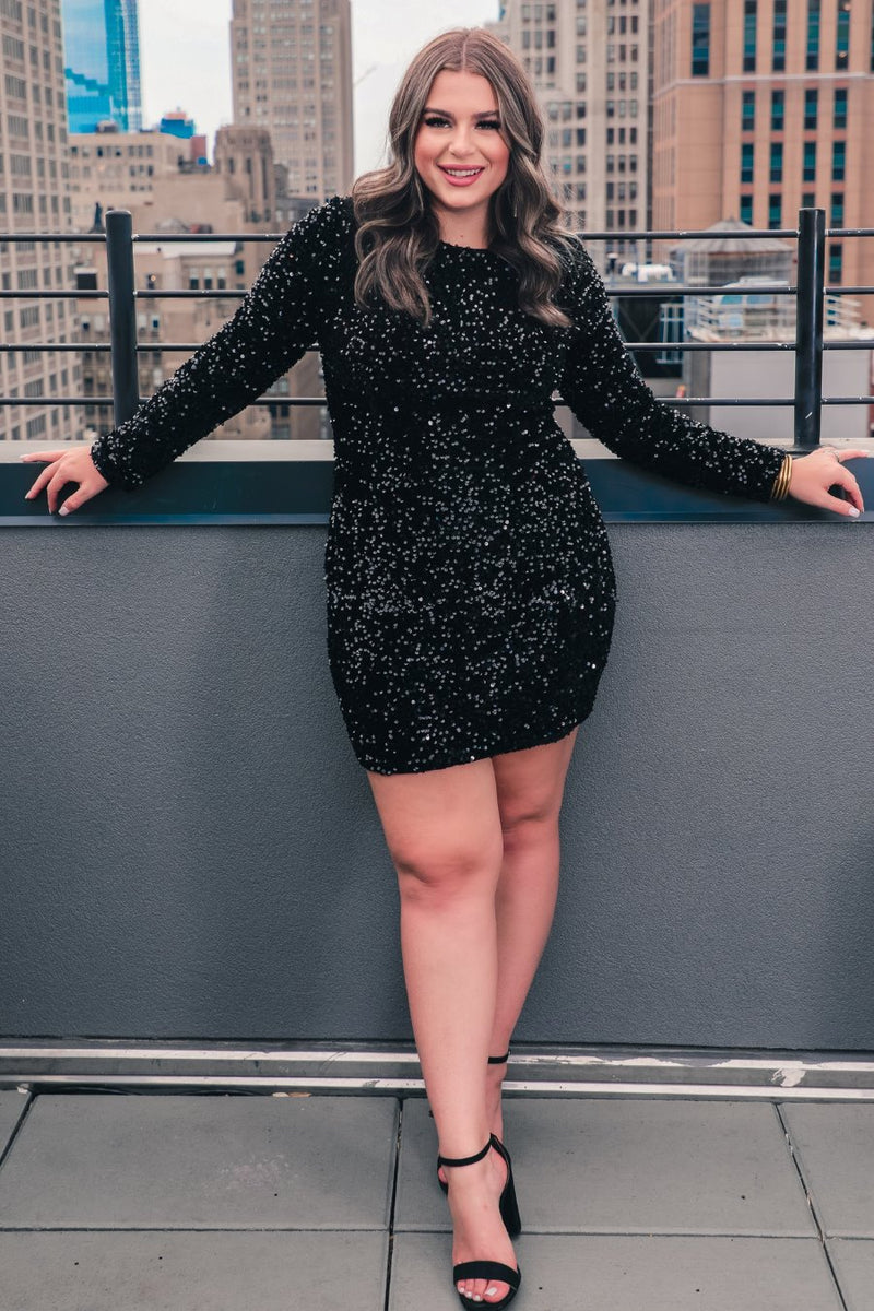 a black long-sleeve dress with shimmering allover sequins detailing, a flattering silhouette, a soft-lined interior, and a back zipper that extends two-thirds down for a polished, easy fit