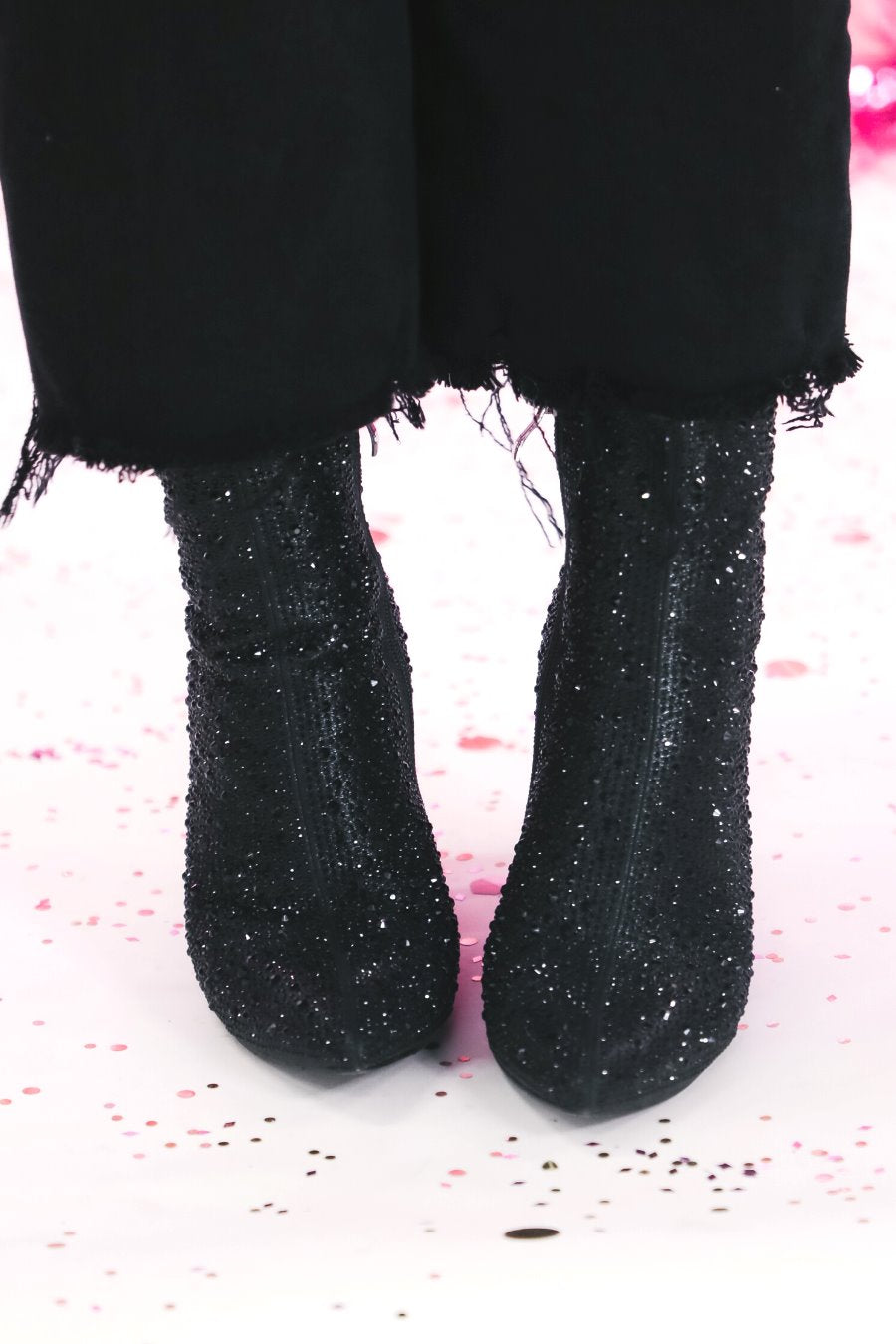 rhinestone-covered booties with a pointed toe, front seam, inside zipper, cushioned flatbed, and a 4" block heel in black