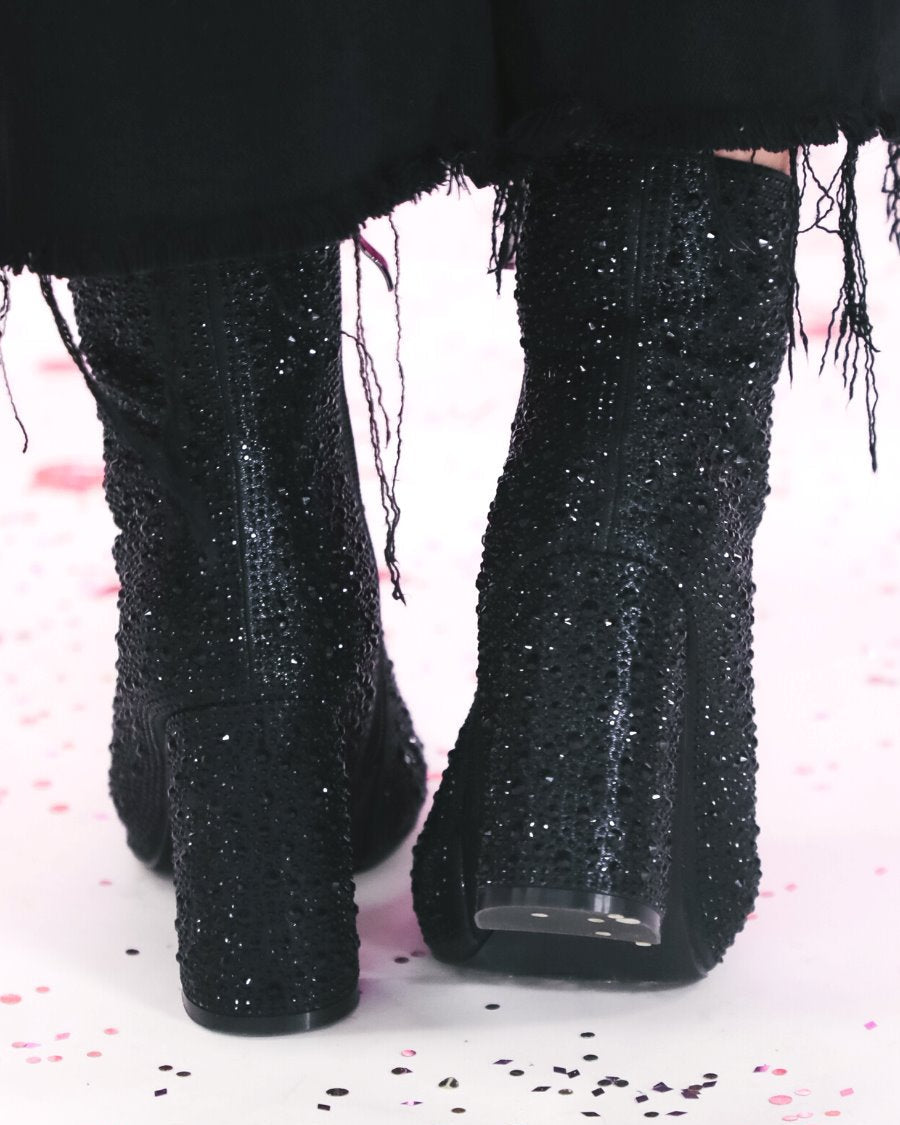 rhinestone-covered booties with a pointed toe, front seam, inside zipper, cushioned flatbed, and a 4" block heel in black