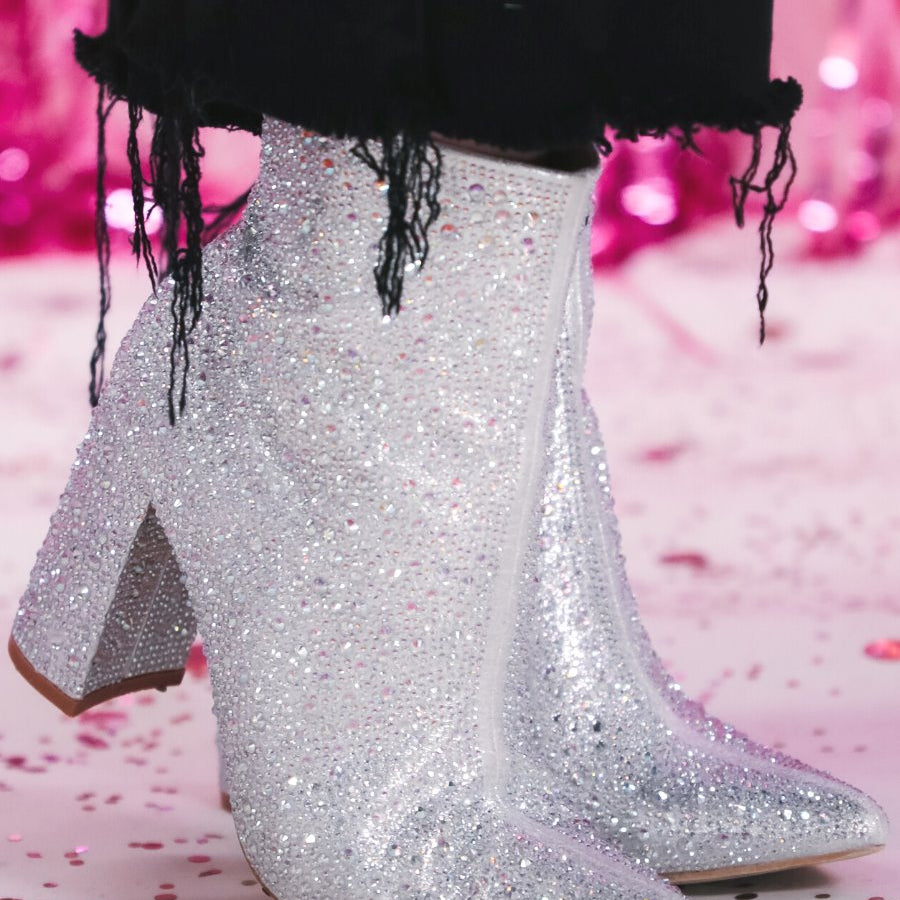 rhinestone-covered booties with a pointed toe, front seam, inside zipper, cushioned flatbed, and a 4" block heel in silver