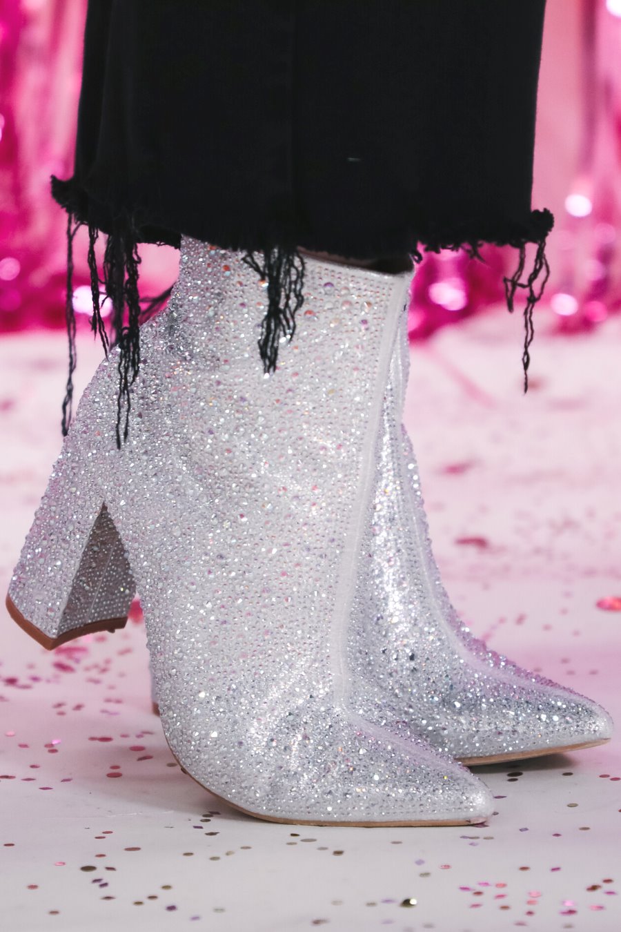 rhinestone-covered booties with a pointed toe, front seam, inside zipper, cushioned flatbed, and a 4" block heel in silver