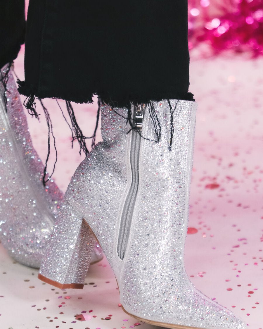 rhinestone-covered booties with a pointed toe, front seam, inside zipper, cushioned flatbed, and a 4" block heel in silver