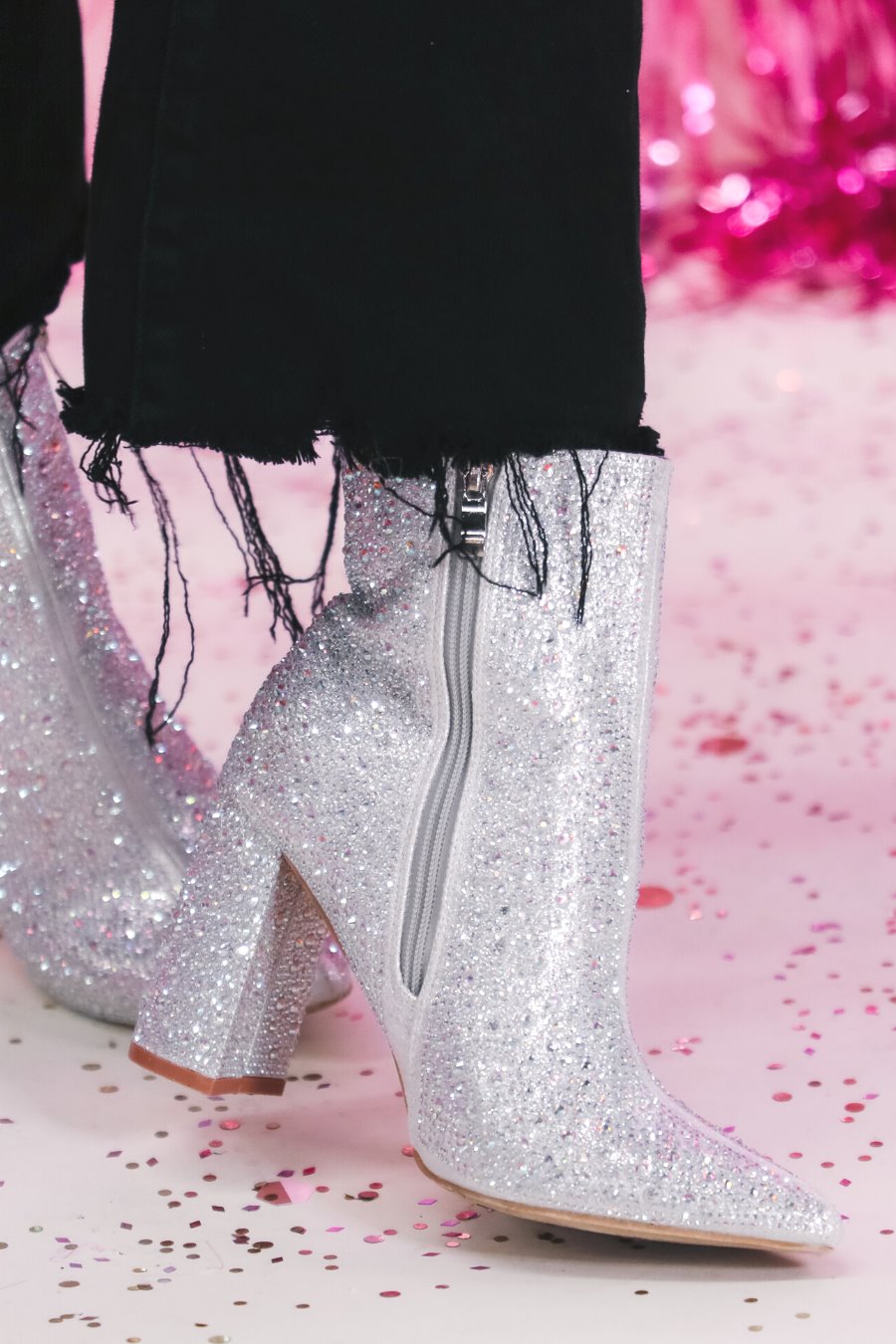 rhinestone-covered booties with a pointed toe, front seam, inside zipper, cushioned flatbed, and a 4" block heel in silver
