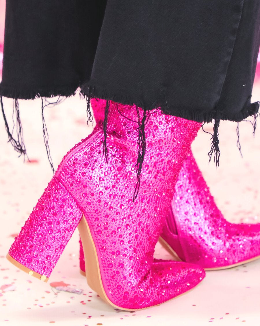 rhinestone-covered booties with a pointed toe, front seam, inside zipper, cushioned flatbed, and a 4" block heel in pink