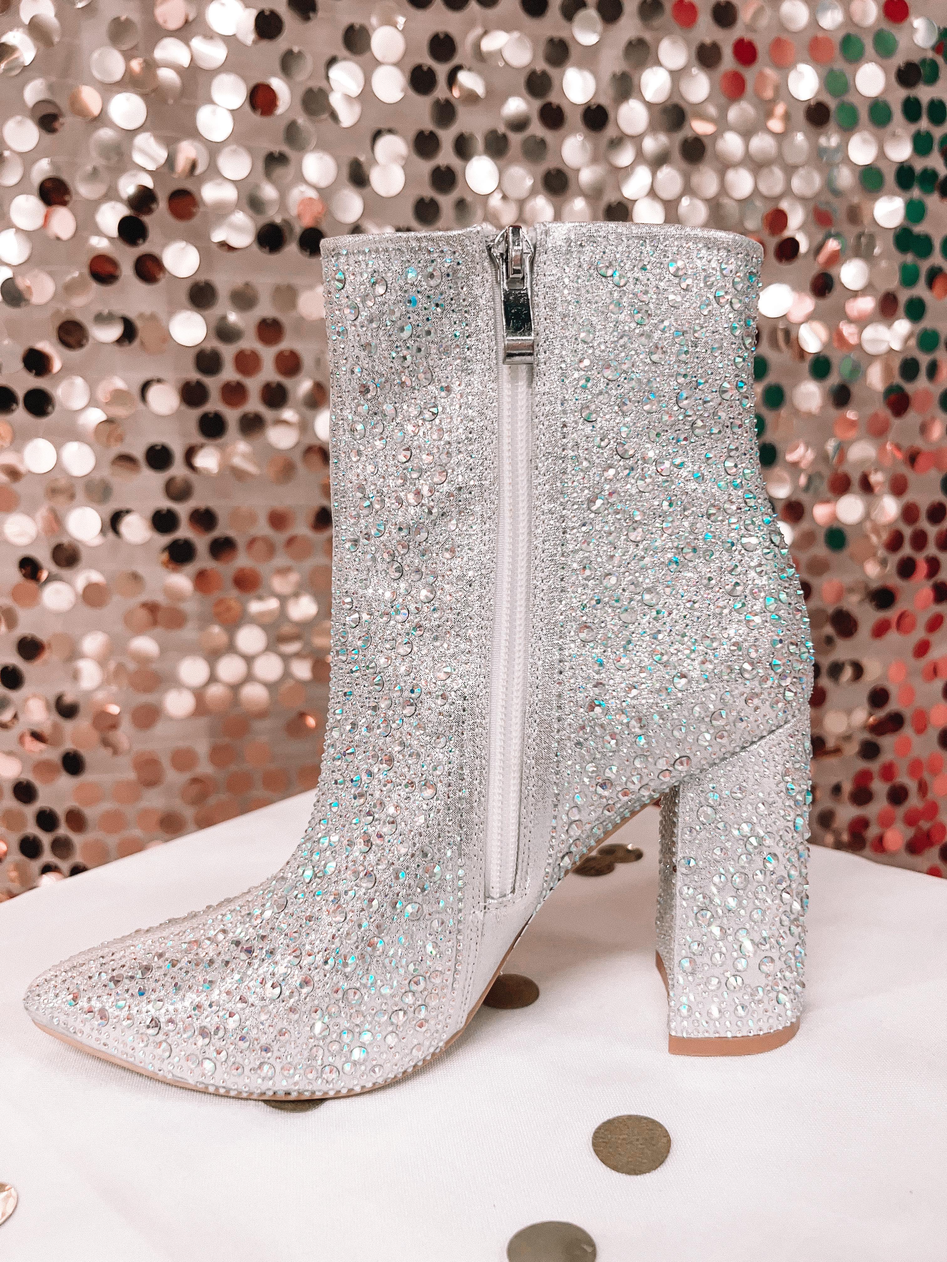 rhinestone-covered booties with a pointed toe, front seam, inside zipper, cushioned flatbed, and a 4" block heel in silver