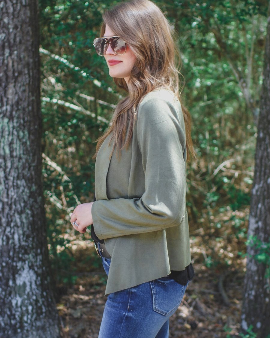 draped open-front silhouette jacket, crafted on a super soft faux suede material with long sleeves, an angled front cropped hem, and subtle seam details on the back in olive