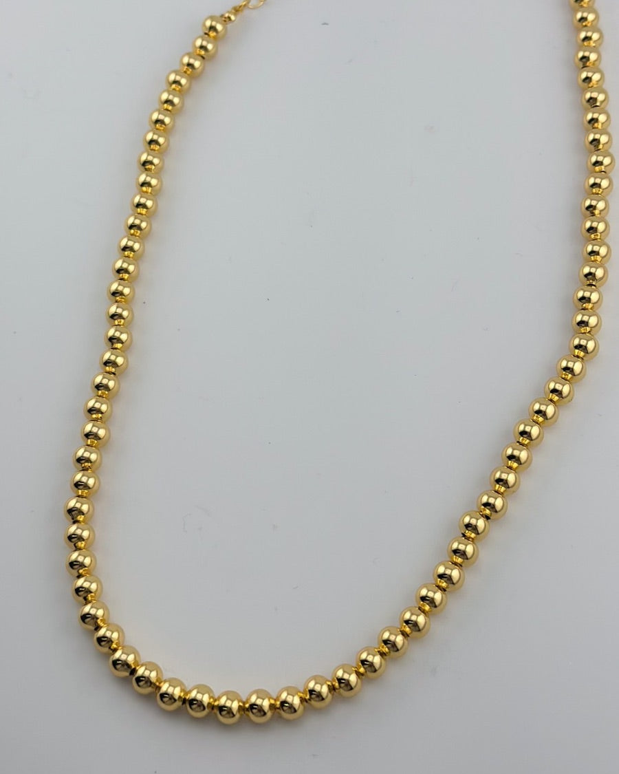 a gold-plated necklace with 6mm brass beads