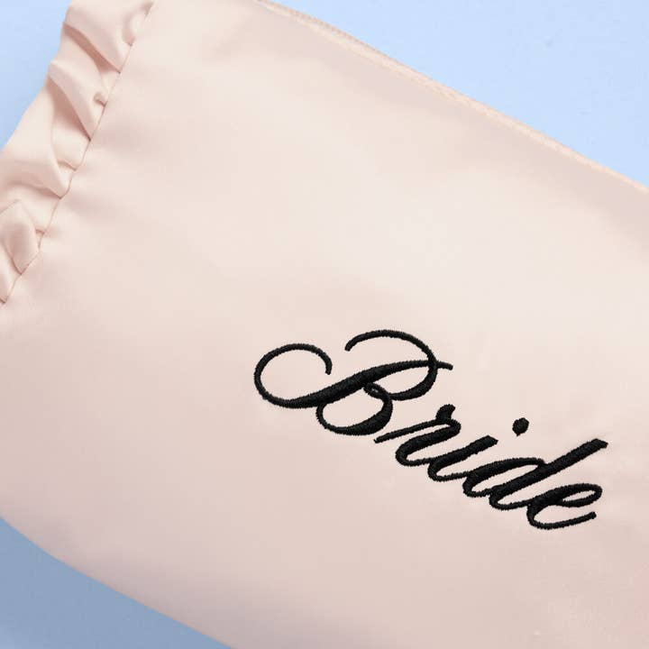 Beige garment with 'Bride' embroidered on it against a light blue background