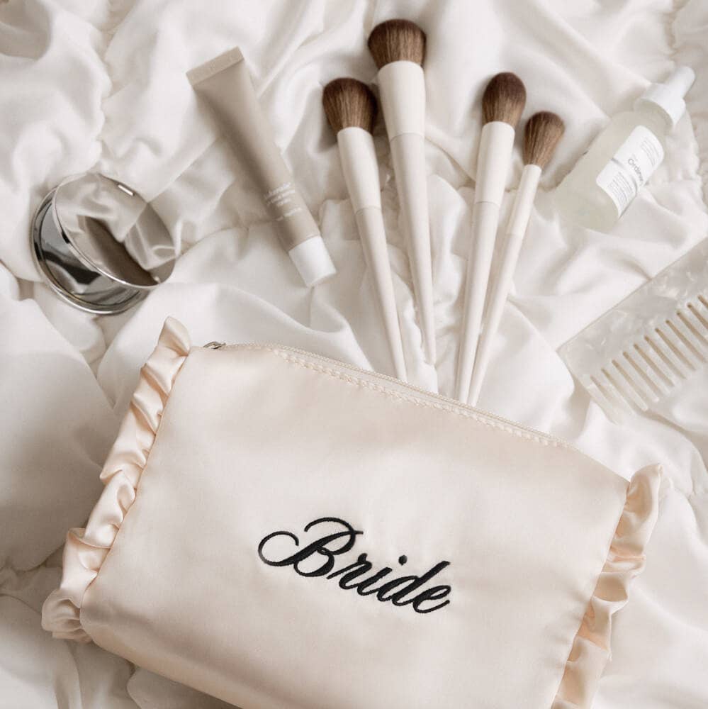 Makeup brushes with a 'Bride' pouch on a white background