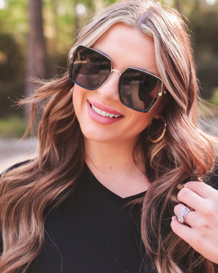 black square frame sunglasses with gold bridge, nose pads, UV protection, and brand name detail (on both the temple and the complimentary black pouch)