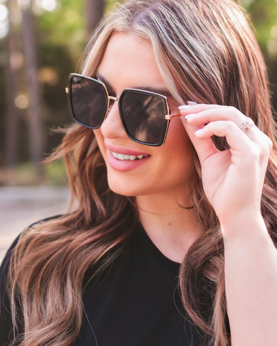 black square frame sunglasses with gold bridge, nose pads, UV protection, and brand name detail (on both the temple and the complimentary black pouch)