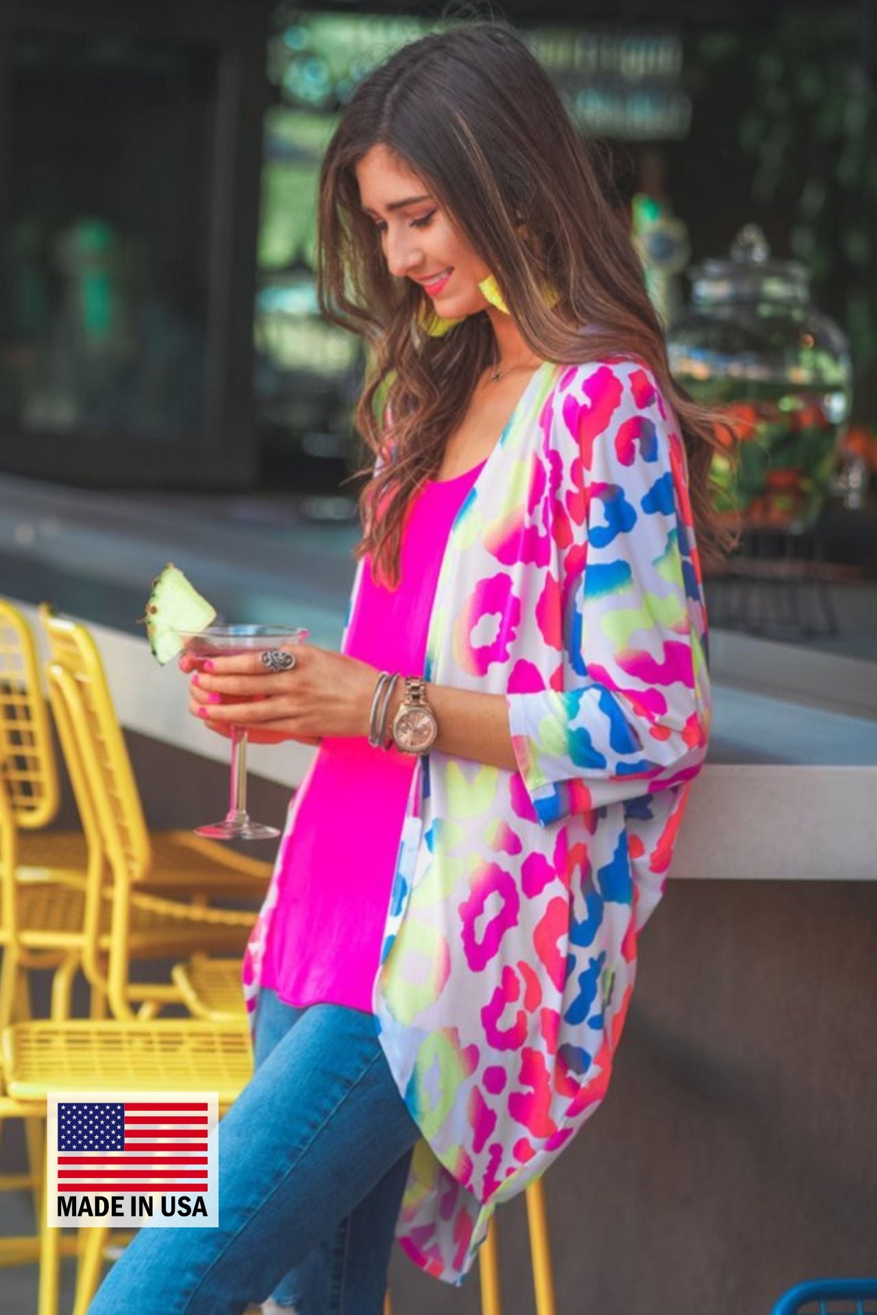 MADE IN USA three-quarter sleeve open front cardigan made of lightweight material that drapes into a cocoon shape on a vibrant leopard print pattern fabric in white