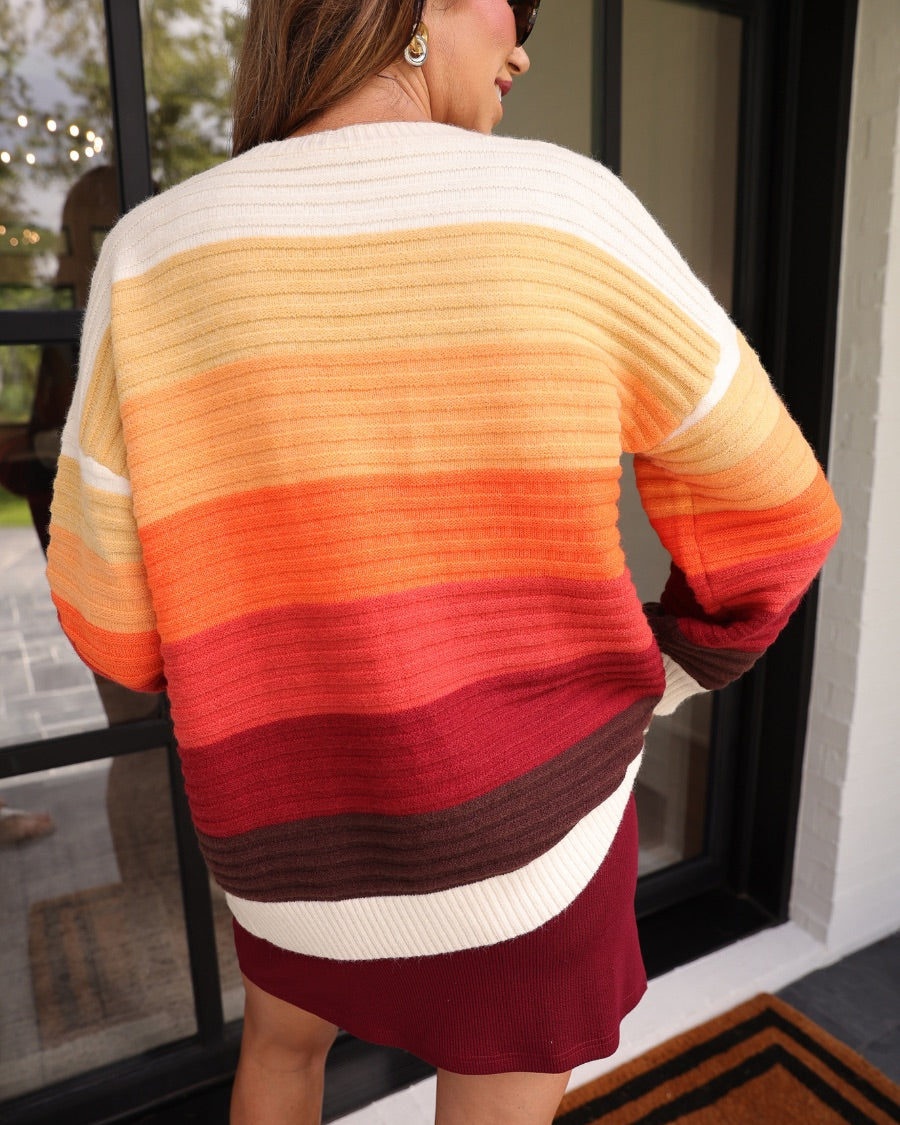 long-sleeve open front cardigan, finished in a vibrant ombré of cream, gold, orange, and rust tones on a soft knit fabric