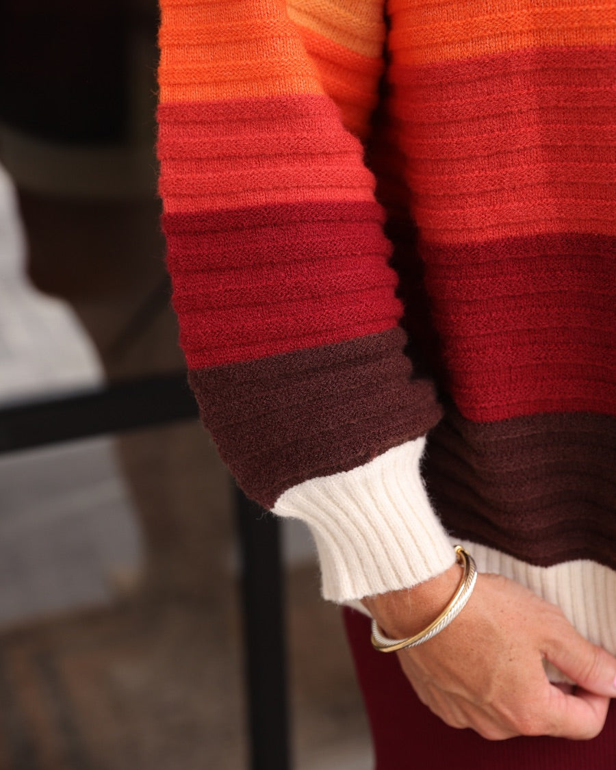 long-sleeve open front cardigan, finished in a vibrant ombré of cream, gold, orange, and rust tones on a soft knit fabric