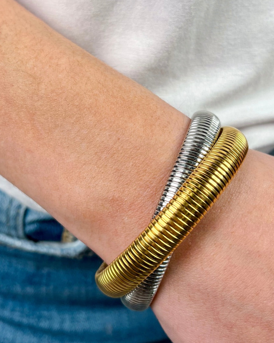 mixed metal bangle of gold and silver with an intertwined design