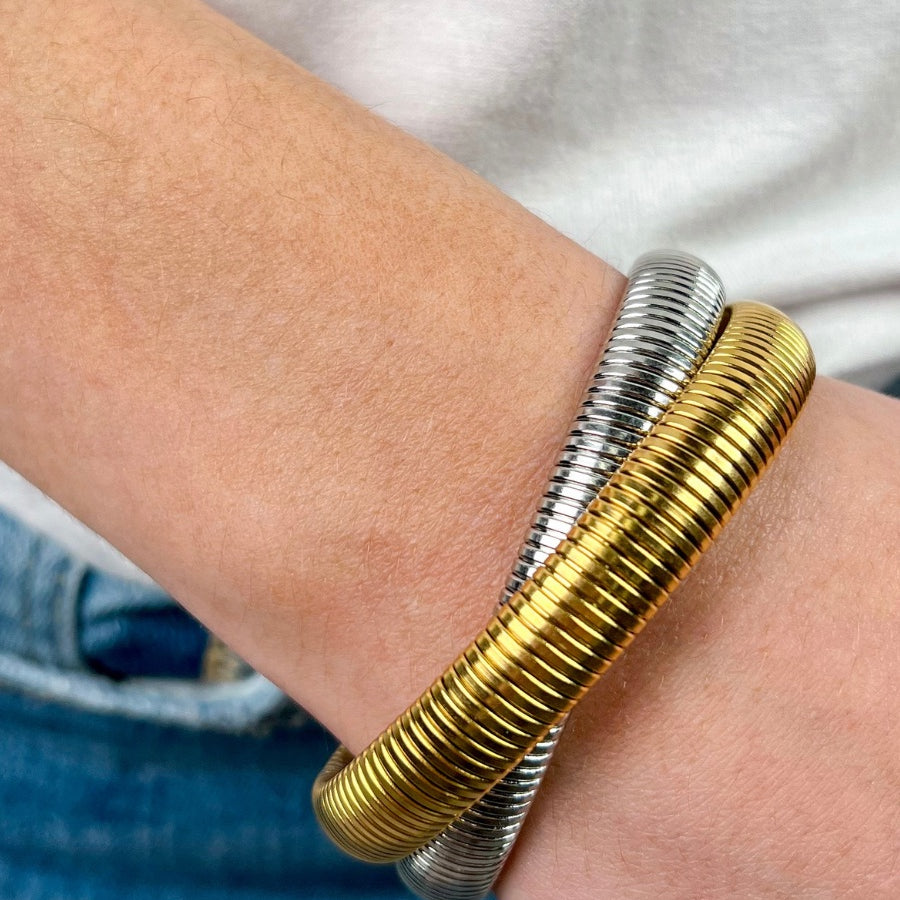mixed metal bangle of gold and silver with an intertwined design
