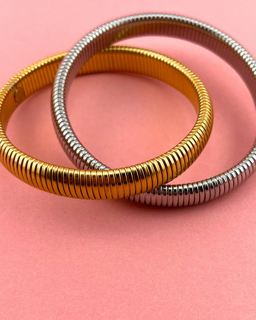 mixed metal bangle of gold and silver with an intertwined design